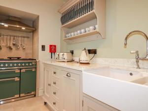 a kitchen with a sink and a stove at Beach View House in Newquay +30 photos