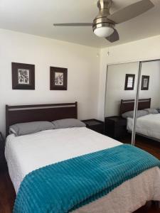 a bedroom with a bed with a blue blanket on it at Charming 3-bedroom house in Ann Arbor