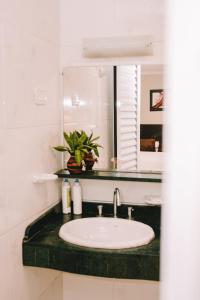 a bathroom with a sink and a mirror at Altos del Iguazu in Puerto Iguazú