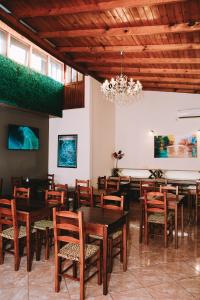 a dining room with tables and chairs and a chandelier at Altos del Iguazu in Puerto Iguazú