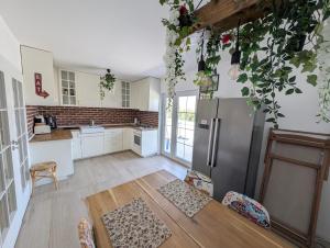 a kitchen with a refrigerator and a table at Casa Pax in Horpaz