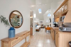 a kitchen and a living room with a sink and a mirror at Montara Penthouse Elevated Comfort Above Downtown Half Moon Bay in Half Moon Bay