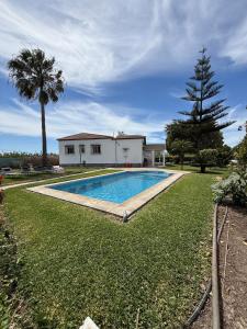 a swimming pool in the yard of a house at Cortijo Celia in Salobreña