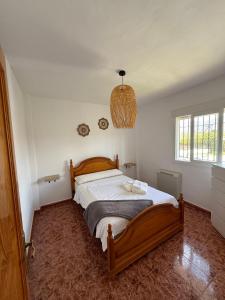 a bedroom with a large bed in a room at Cortijo Celia in Salobreña