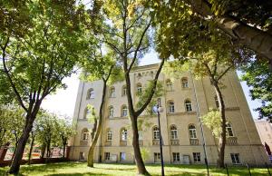 a large building with trees in front of it at Dom Sonata in Gdańsk