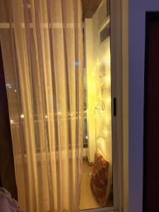 a room with a window with curtains on it at Couple Canvas- Luxurious 1-BHK Peaceful Apartment in Siroli +45 photos