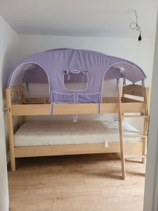 a bunk bed with a tent on top of it at Ferienhaus Klara in Schweich