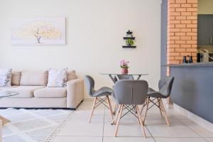a living room with a table and chairs and a couch at Prime Ridge in Midrand