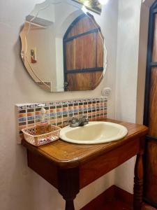 a bathroom with a sink and a mirror at Sunrise Guest House in León +67 photos