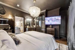 a bedroom with a large white bed and a chandelier at Modern Spacious 3 bed 3 12 bath suites in Dallas +40 photos