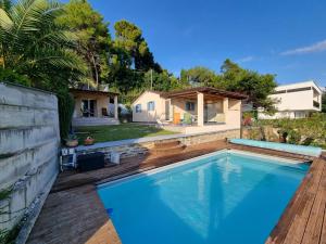 a swimming pool in front of a house at Luna's Seaview Residence - Ankaran in Ankaran