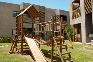 een houten speeltuin voor een huis bij Sol&coqueiros in Pôrto de Pedras