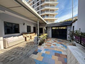 ティラナにあるAlina Hostelの建物のある家のソファのあるパティオ