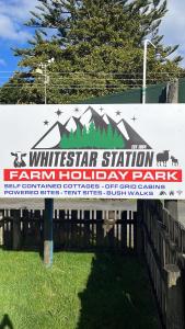 a sign for a white star station farm holiday park at White Star Station Farm Holiday Park in Coromandel Town