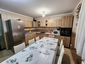 a kitchen with a table and a refrigerator at Casa Teleferic in Buşteni +38 photos