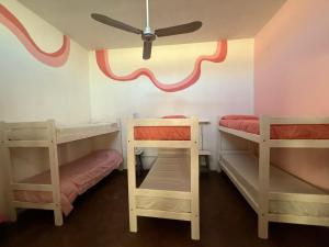 a room with two bunk beds and a ceiling at 3260HOSTEL in Concepción del Uruguay
