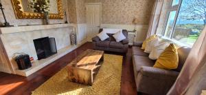 a living room with a couch and a fireplace at Two Bedroom Holiday Home in Kilronan in Inis Mor