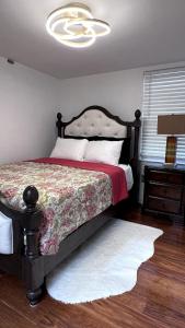 a bedroom with a bed and a chandelier at Chic City Guesthouse Getaway in Riverside