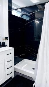 a white bathroom with a tub and a shower at Chic City Guesthouse Getaway in Riverside +37 photos
