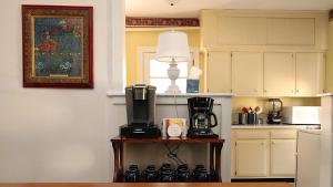 a kitchen with a table with a coffee maker and a lamp at Saltwood House 4 Bedroom in Cape May