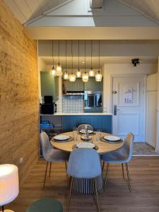 a dining room with a wooden table and chairs at 812 Manoir Savoie in Bourg-Saint-Maurice