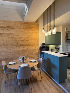 a dining room with a table and chairs in a kitchen at 812 Manoir Savoie in Bourg-Saint-Maurice