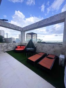 a patio with two beds and a tent on top at Casa Buddha - Pool, Jacuzzi and private terrace in Cancún