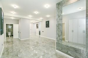 a large mirror in the middle of a room with a marble floor at SULTAN Luxury Apartment in Nizami street in Baku +187 photos