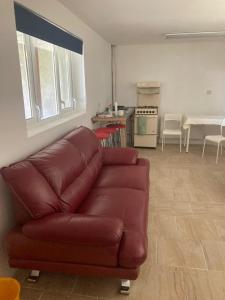 a living room with a brown couch and a kitchen at Four Seasons House - Affordable&Quiet Stay in Donegal in Milford