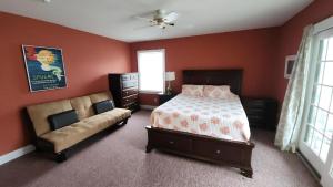 a bedroom with a bed and a couch at 1608 Maryland Henrys Hideaway in Cape May