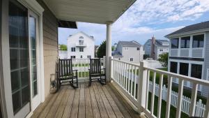 a porch with two chairs on a house at 1608 Maryland Henrys Hideaway in Cape May