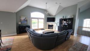 a living room with a large couch and a fireplace at 1608 Maryland Henrys Hideaway in Cape May