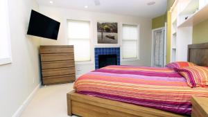 a bedroom with a bed and a tv on the wall at 516 Mistletoes In The Sand, Cape May Beach in Villas