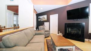 a living room with a couch and a fireplace at 516 Mistletoes In The Sand, Cape May Beach in Villas