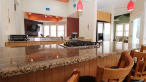a kitchen with a counter with a stove top oven at 516 Mistletoes In The Sand, Cape May Beach in Villas