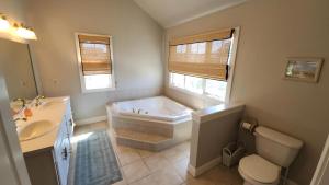 a bathroom with a tub and a toilet and a sink at 1608 Maryland Henrys Hideaway in Cape May +31 photos