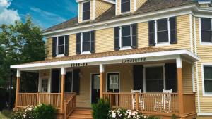 a large house with a porch with a deck at 1136 And 1138 Lafayette Street Condo in Cape May