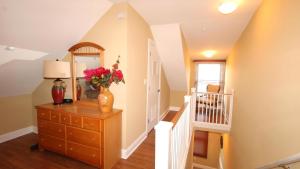 a room with a dresser with a vase of flowers on it at 1136 And 1138 Lafayette Street Condo in Cape May
