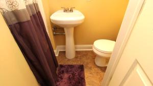 a bathroom with a white toilet and a sink at 1136 And 1138 Lafayette Street Condo in Cape May +6 photos