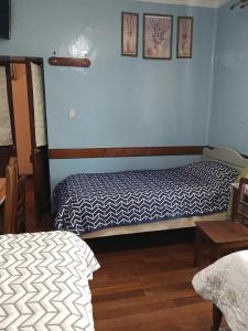 Ένα ή περισσότερα κρεβάτια σε δωμάτιο στο Hostal Residencial Avenida