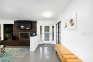 a living room with a couch and a fireplace at UF SUNSHINE HOUSE - Patio & BBQ - Chef Kitchen - EV Car Station - Upscale Neighborhood! in Gainesville