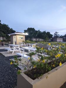 a group of picnic tables in a field of flowers at Welcome to Cozy Staycation in Suba