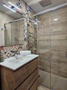a bathroom with a sink and a shower at Mural del Castillo II, La Alberca in La Alberca