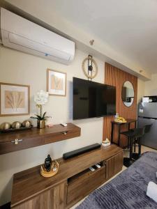 a living room with a large screen tv on the wall at Welcome to Cozy Staycation in Suba +47 photos