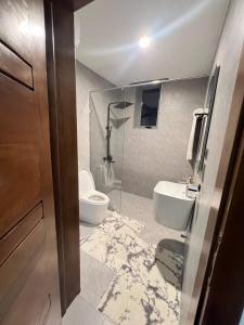 a bathroom with a toilet and a sink at Ensuite studios luxury apartment Pool and balcony in Accra