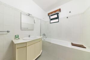 a white bathroom with a sink and a mirror at Casa do Massapez by Mth in Santa Cruz +30 photos