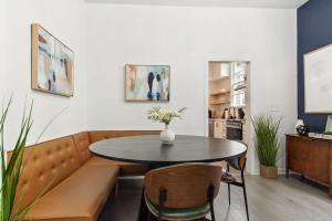 a dining room with a table and a couch at Charming Canal Street Family Retreat in Heart of NOLA in New Orleans