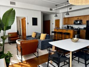 a living room with a couch and a table at Stylish Industrial Loft in Warehouse District in New Orleans
