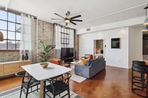 a living room with a couch and a table at Stylish Industrial Loft in Warehouse District in New Orleans
