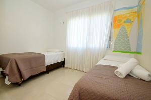 Una cama o camas en una habitación de Apto com piscina e churrasqueira VS6418 22 fotos más